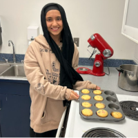 Student baking muffins